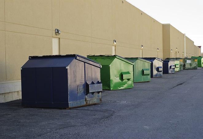a pile of demolition waste sits beside a dumpster in a parking lot in Garrett IN